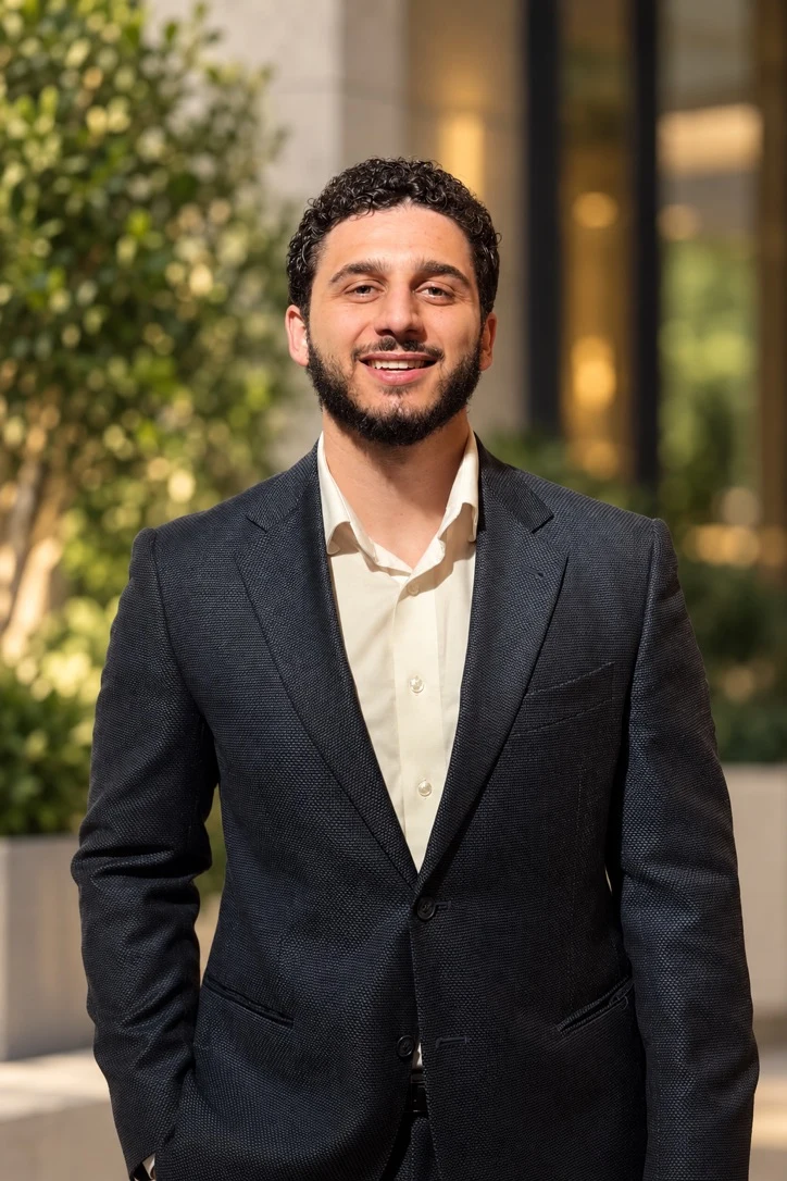 Firas Bdaiwi, smiling, in a dark suit outdoors